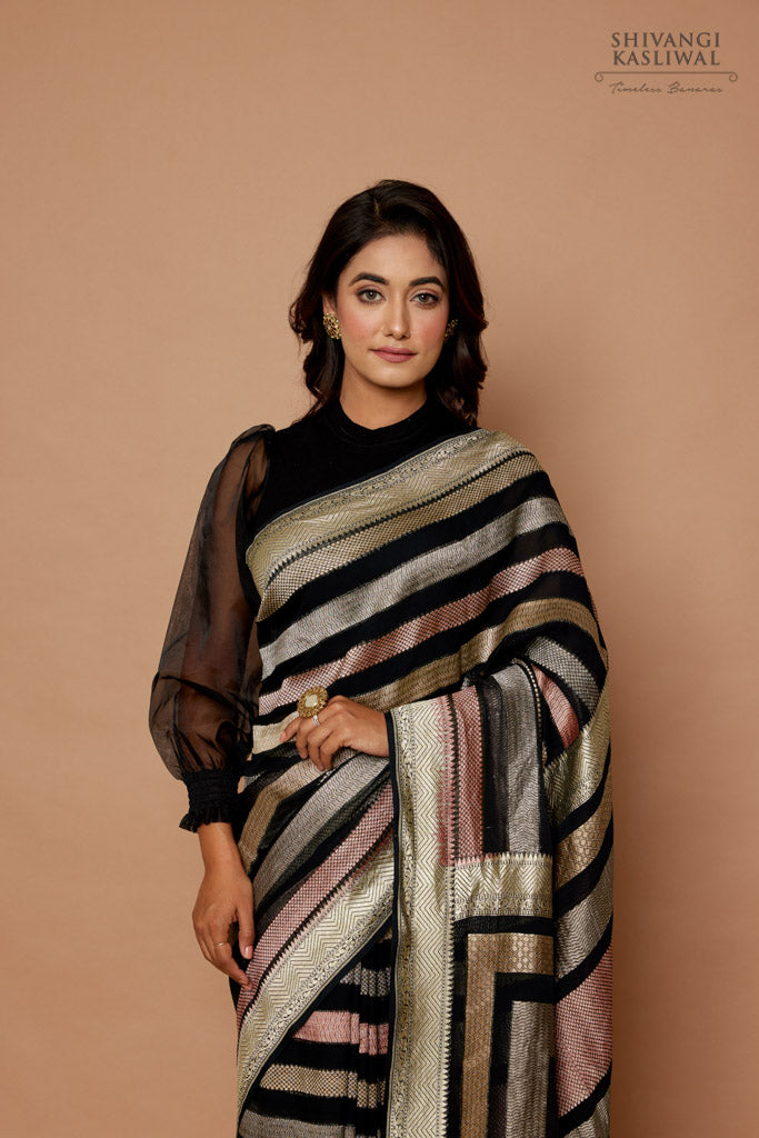Stunning black Banarasi georgette saree with gold zari floral jaal and  minakari weaving (colored threads used along with zari, you can see flowers  in different colors). The weaving is simply spectacular, fabric